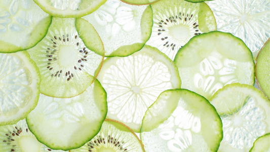 Refreshing kiwi and cucumber smoothie with Wellsprout Super Green Powder, served in a tall glass with ice and mint garnish