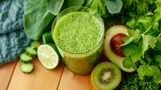Creamy avocado green shake with Wellsprout Super Green Powder, served in a glass, topped with cacao nibs and honey drizzle