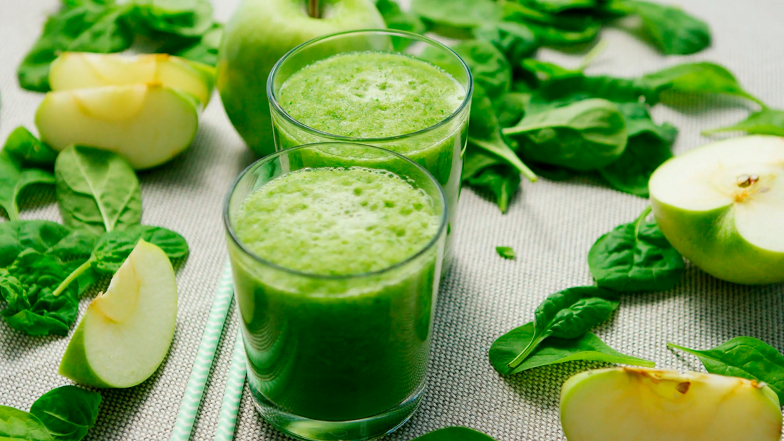Fresh apple and banana green smoothie with Wellsprout Super Green Powder, served in a glass with chia seeds and almonds