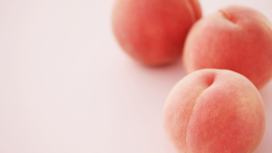 Peach smoothie with Wellsprout Super Green Powder, blended with banana, served in a glass with chia seeds topping